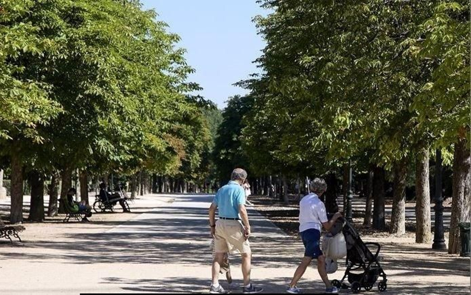 Abuelos paseando a su nieto. // EP