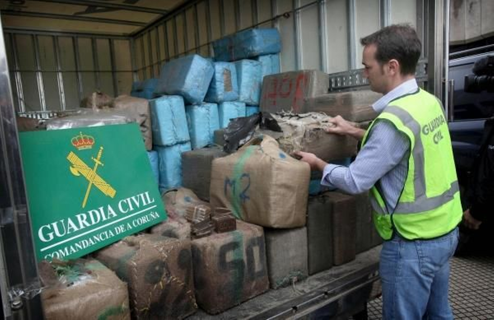 Un Policía custodia los fardos de hachís. (Foto: Cabalar)