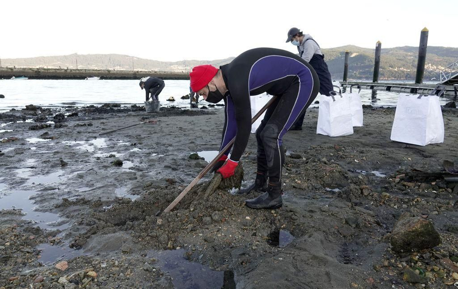 Iago Soto, patrón mayor de la Cofradía de Vigo, recogiendo ayer residuos en la playa de Ríos.