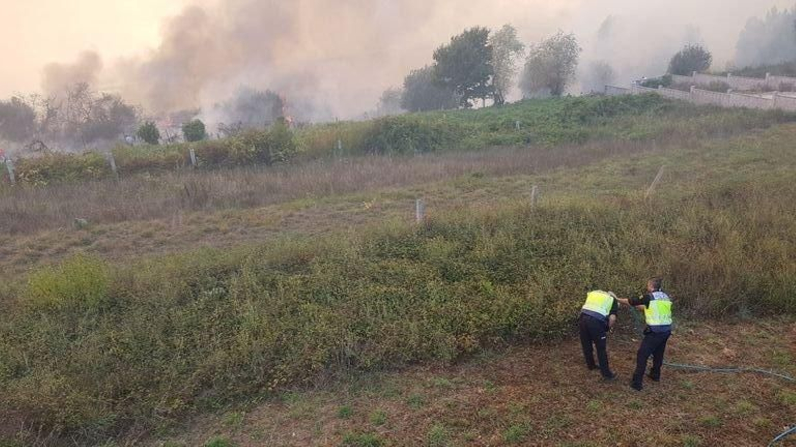 Policías  en el Parque Tecnológico, con un incendio cerca.