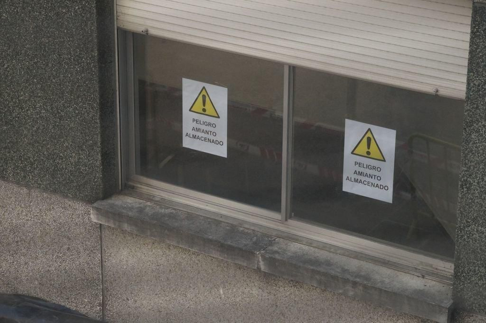 En los cristales del antiguo Xeral aparecen advertencias sobre el peligro del amianto.