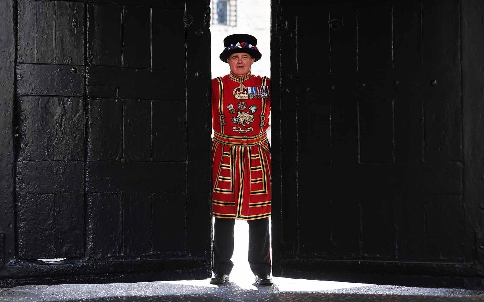 Uno de los guardianes de la Torre de Londres, conocidos como "beefeaters" durante la reapertura oficial de la Torre de Londres tras permanecer más de tres meses cerrada por el coronavirus. EFE/ Andy Rain