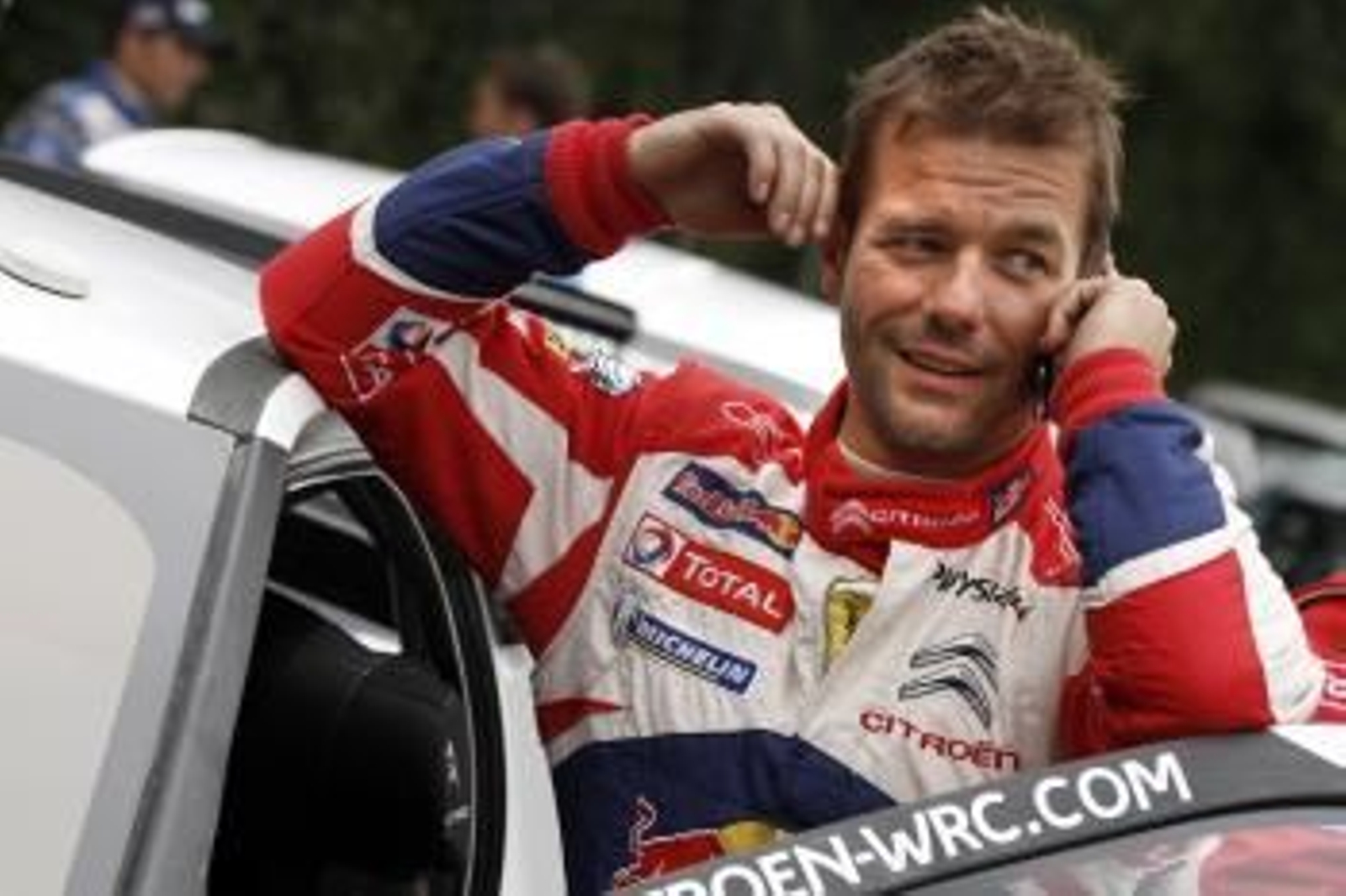 Loeb habla por telefono en uno de los rallys del Mundial.