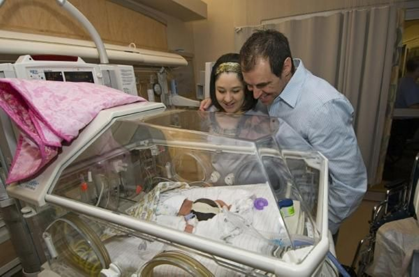 Los felices padres de los quintillizos observan a sus pequeños.  (Foto: Gary Williams)