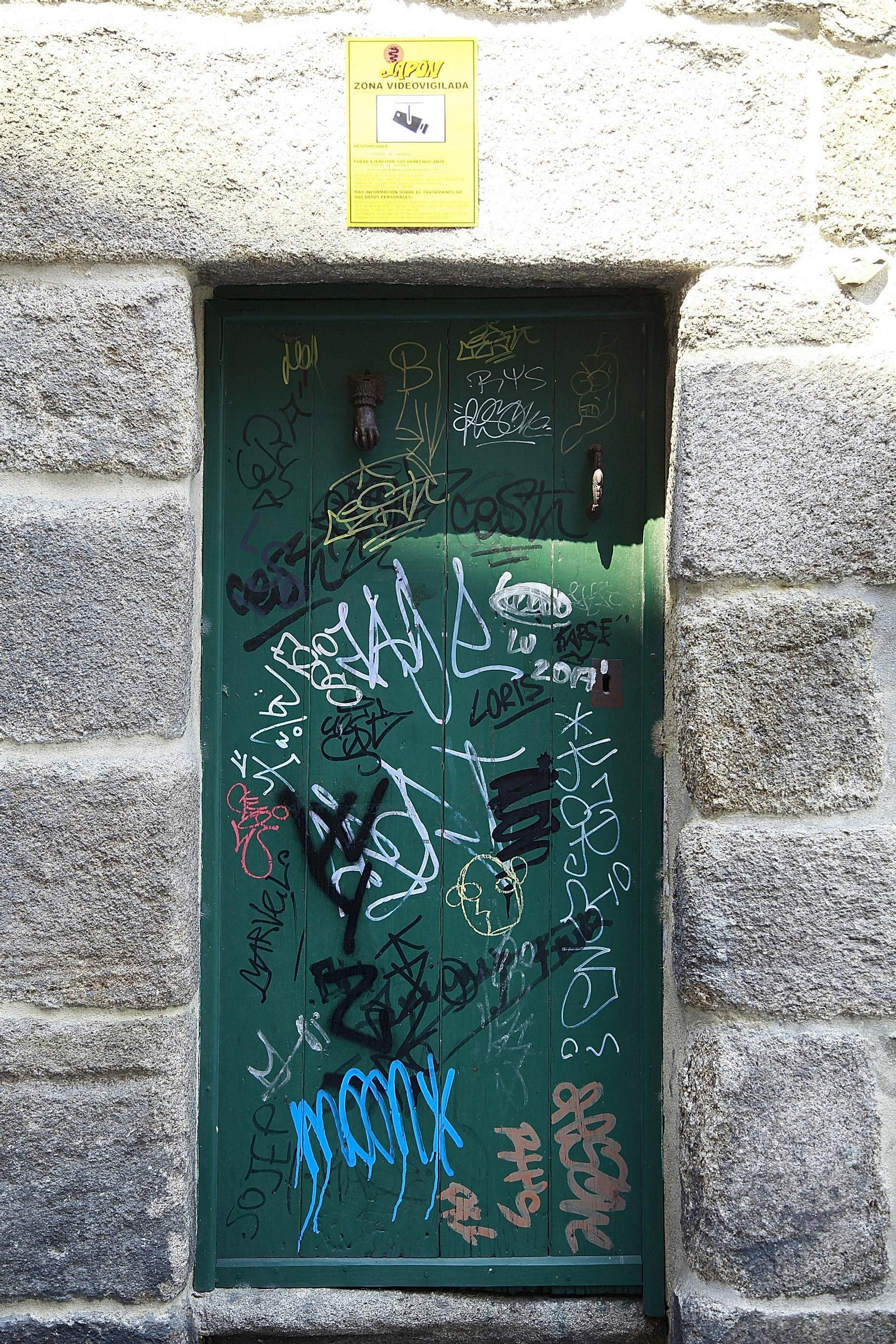 Pintadas en una puerta del exterior de la Catedral de Ourense.
