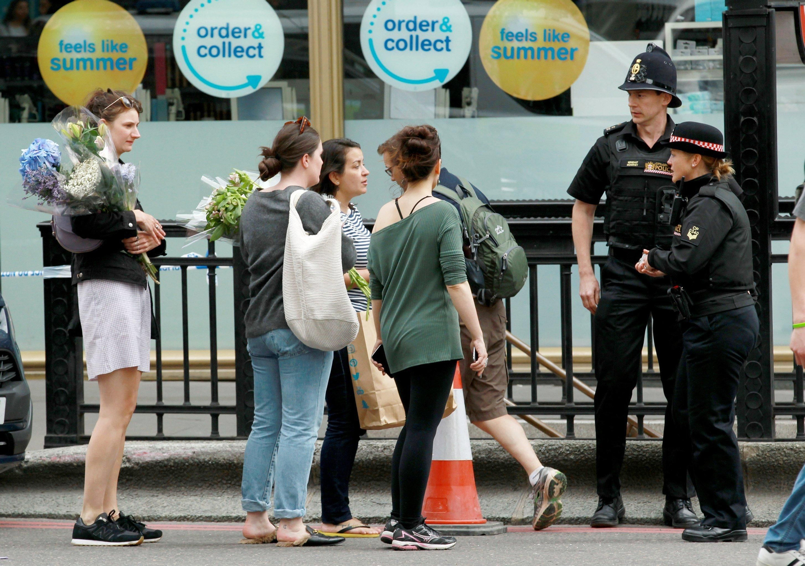 Varias personas acuden con flores para depositar en el lugar donde ocurrieron los atropellos.