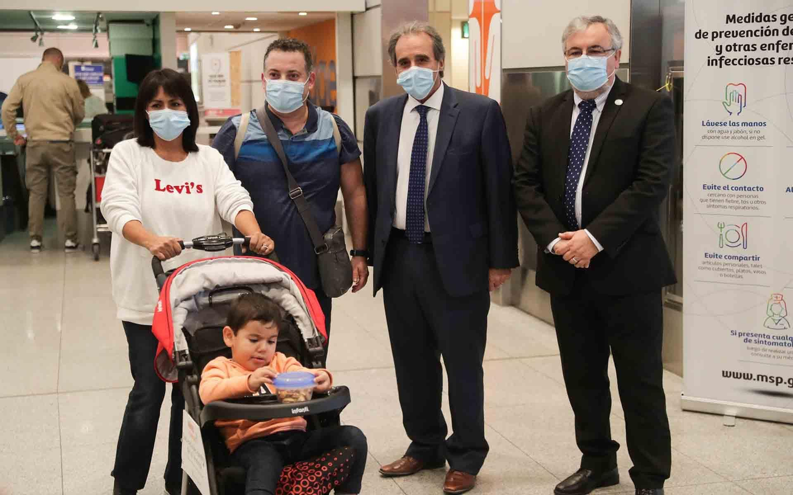 Una familia de turistas posa con el viceministro de Turismo, Remo Monzeglio (2-d) y el secretario general de la Cámara Uruguaya de Turismo, Francisco Rodríguez (d), en el Aeropuerto Internacional de Carrasco. EFE/Federico Anfitti