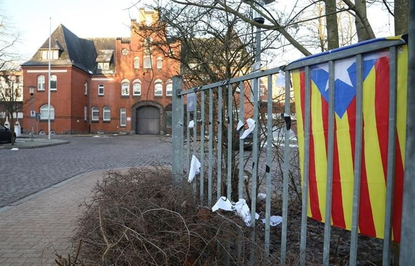 Una estelada (izq) colocada cerca de la prisión de Neumünster (Alemania), donde el expresidente de la Generalitat catalana Carles Puigdemont permanece detenido