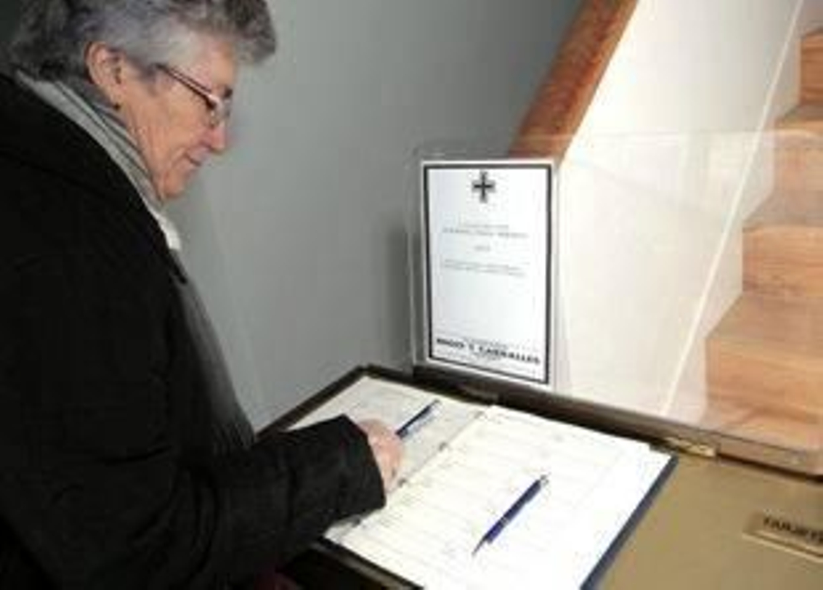 Una vecina de Vilalba firma en el libro de condolencias en la vivienda familiar de Manuel Fraga.